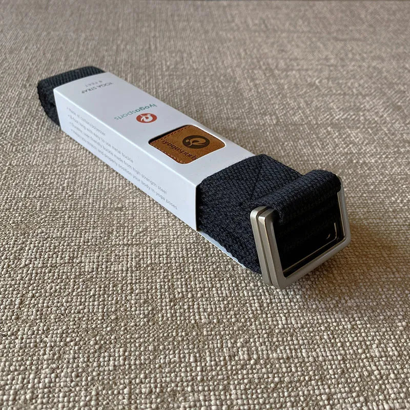 Supplier photograph of the black woven stretch strap with metal buckle and original packaging.